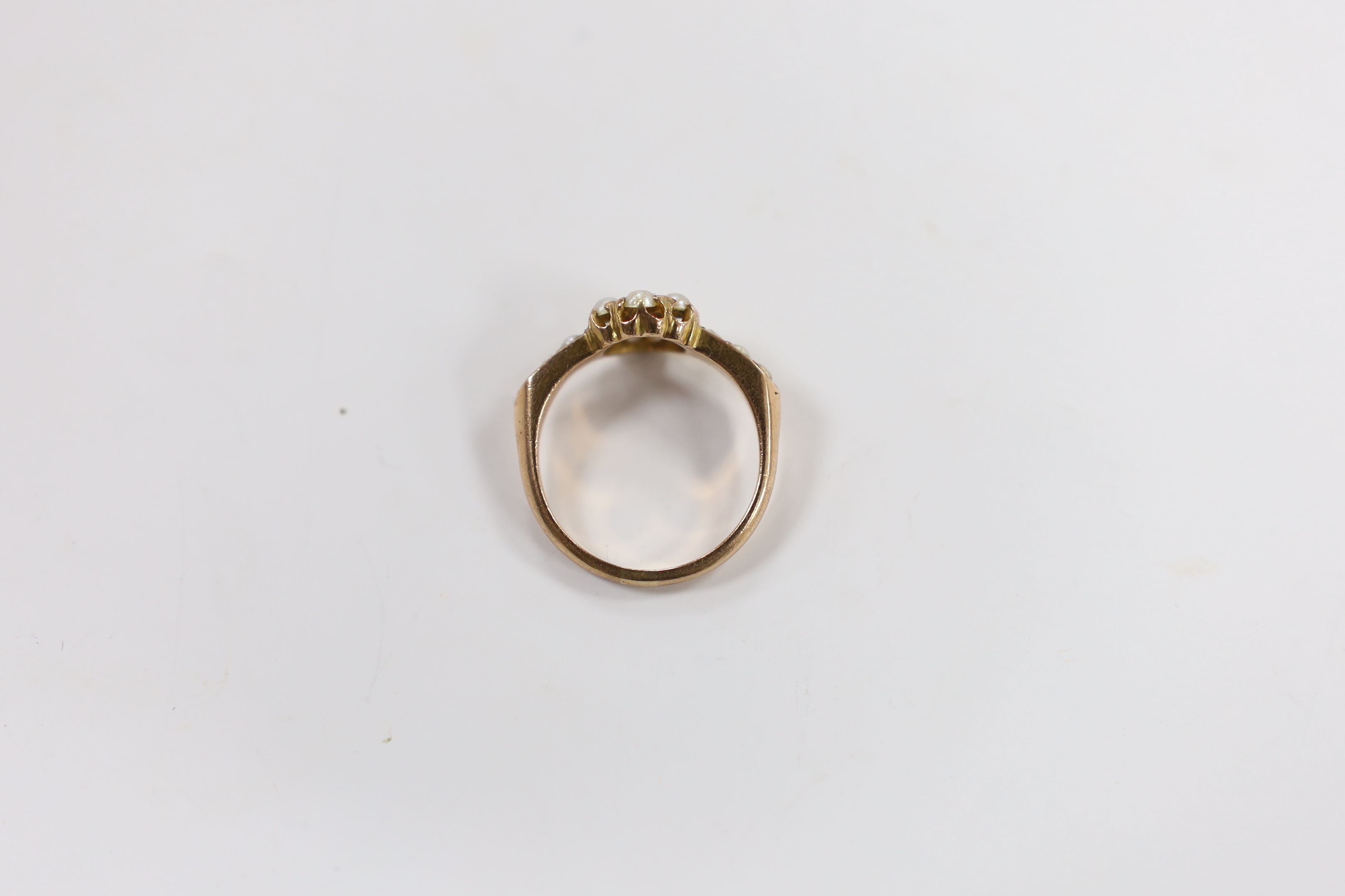 A yellow metal, red paste and split pearl cluster set ring, size O, gross weight 3 grams (one pearl missing).